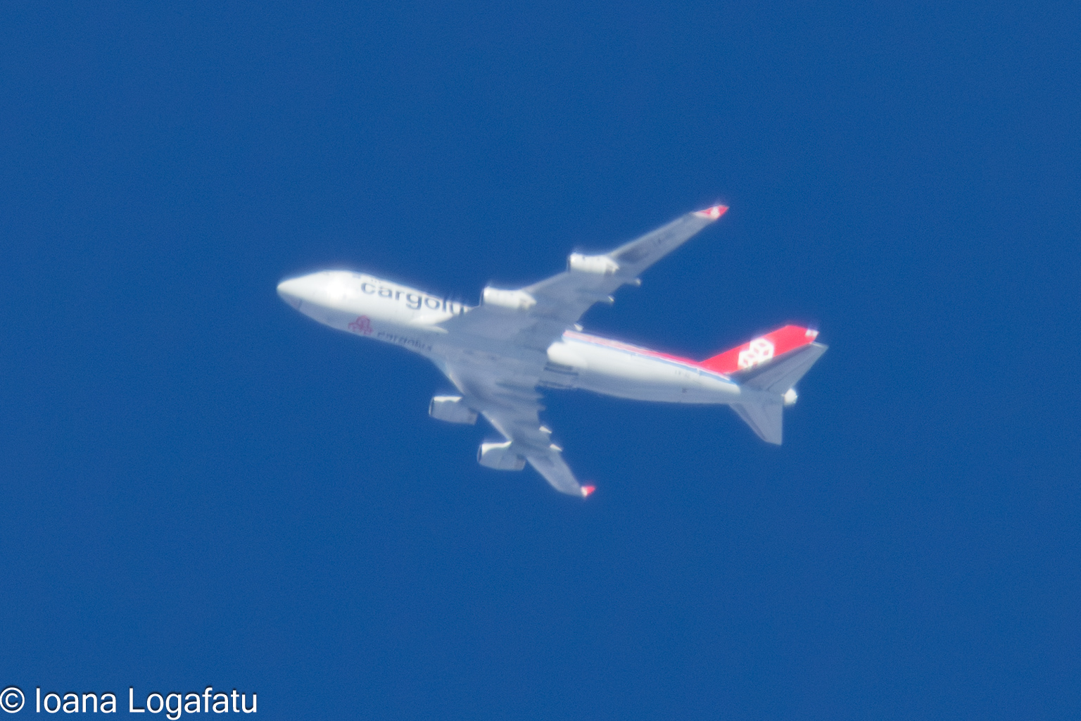 Air cargo flight soaring high above clear skies